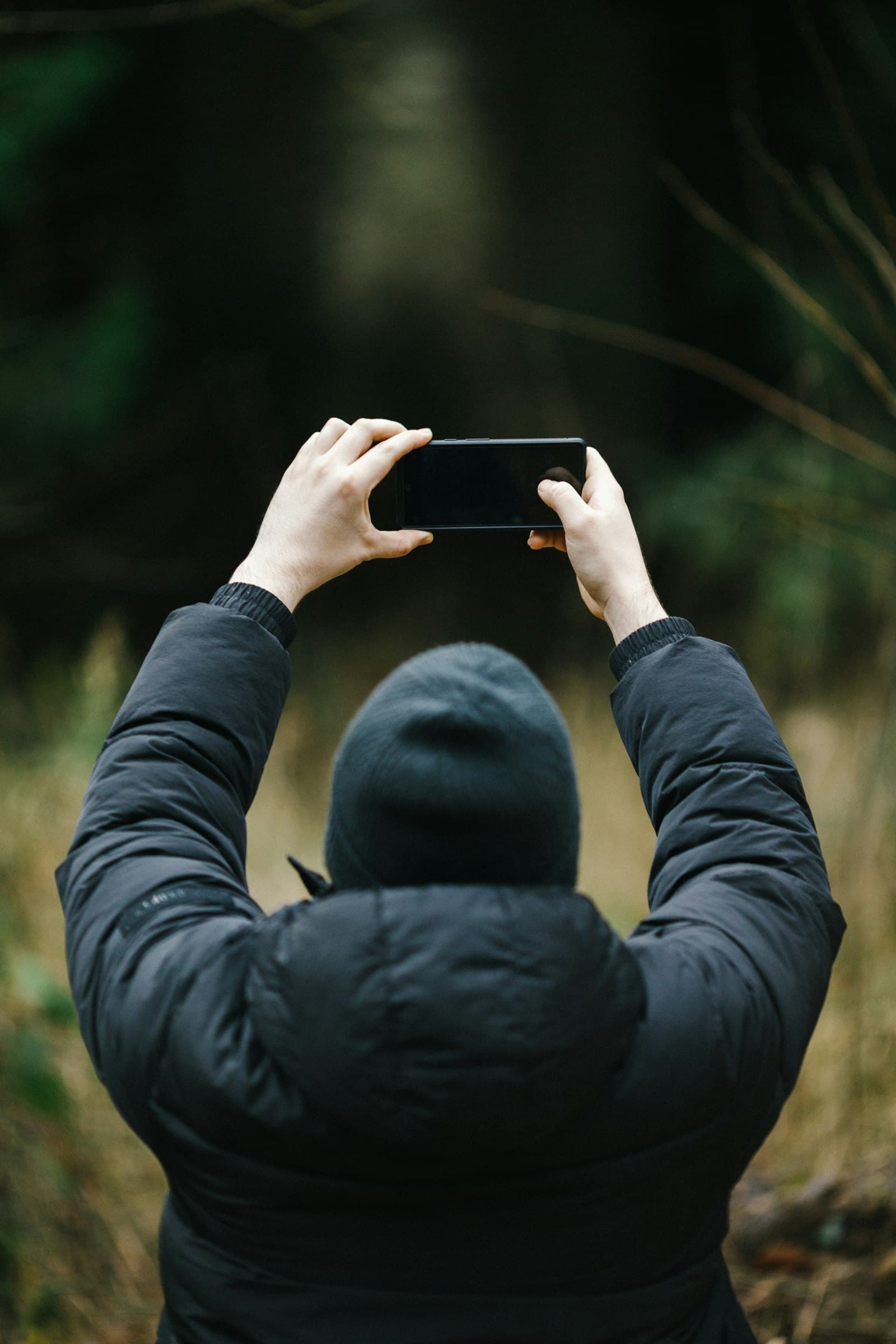 A person outdoors using their phone